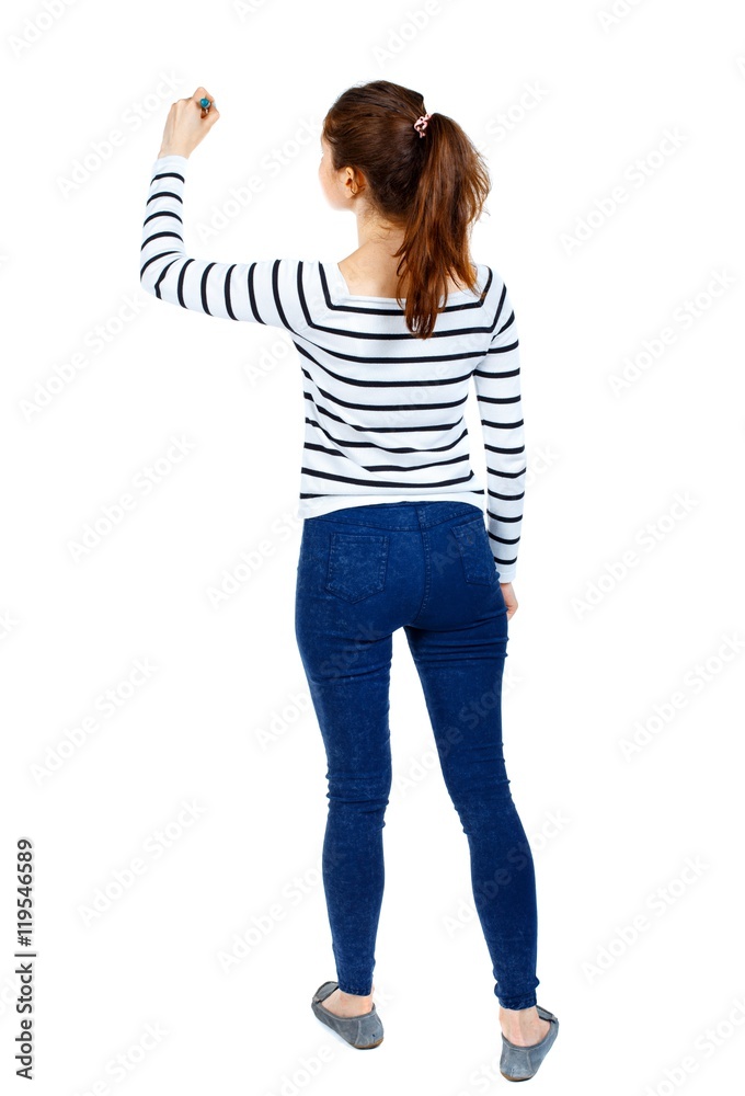 back view of writing beautiful woman. Girl in a striped sweater thoughtfully draws a pen. back view of writing beautiful woman. Girl in a striped sweater thoughtfully draws a pen.
