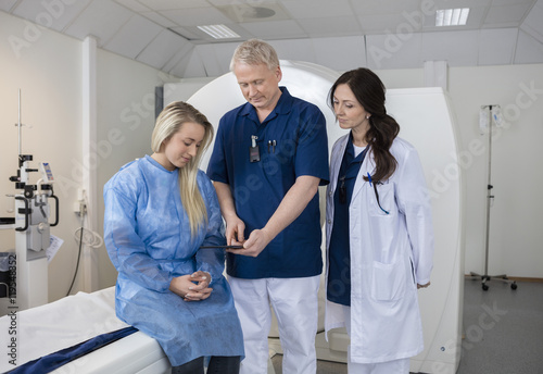 Professional With Patient And Doctor Using Computer Before MRI S