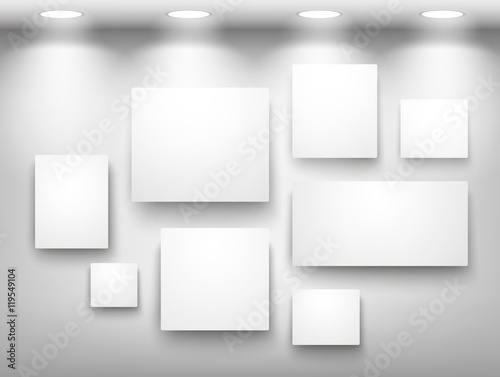 Gallery of empty frames on wall with lighting