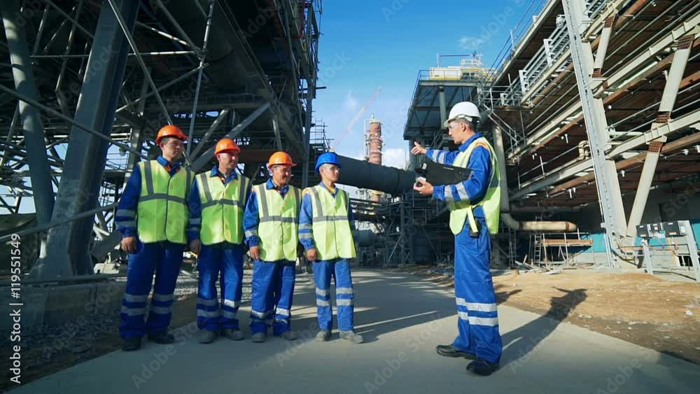 Industrial engineer and workers discussing in factory Industrial engineer and workers discussing in factory
