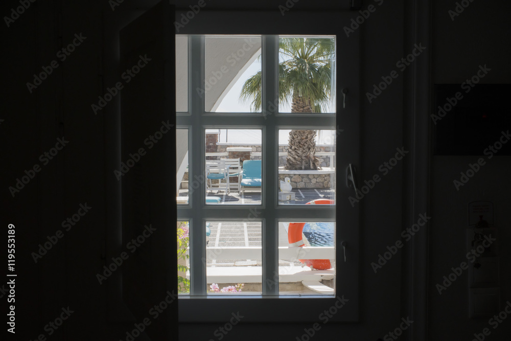 view through the window to the pool with palm tree view through the window to the pool with palm tree