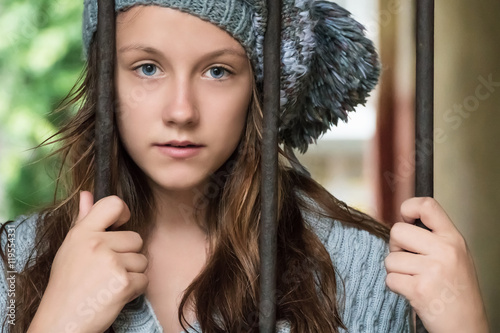 Portrait of a woman behind bars photo