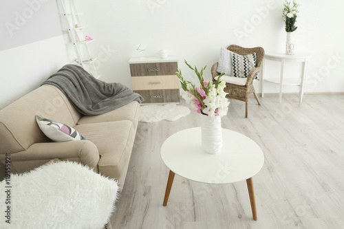 Room with bouquet of flowers in vase on wooden table