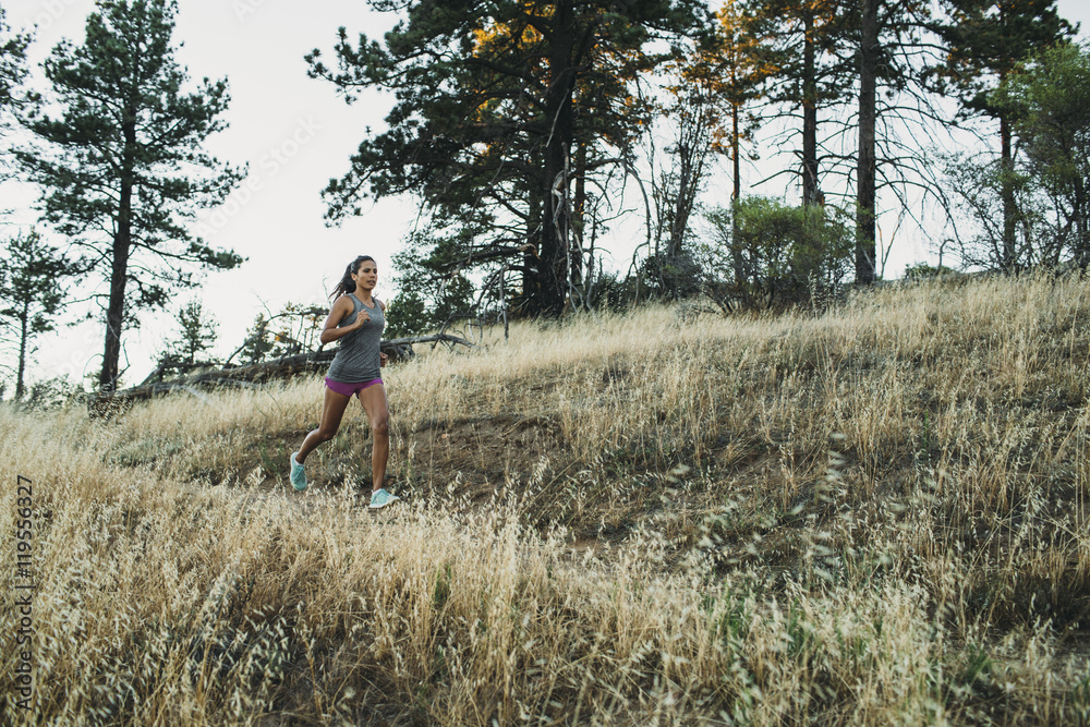 Woman running in grassy field Woman running in grassy field