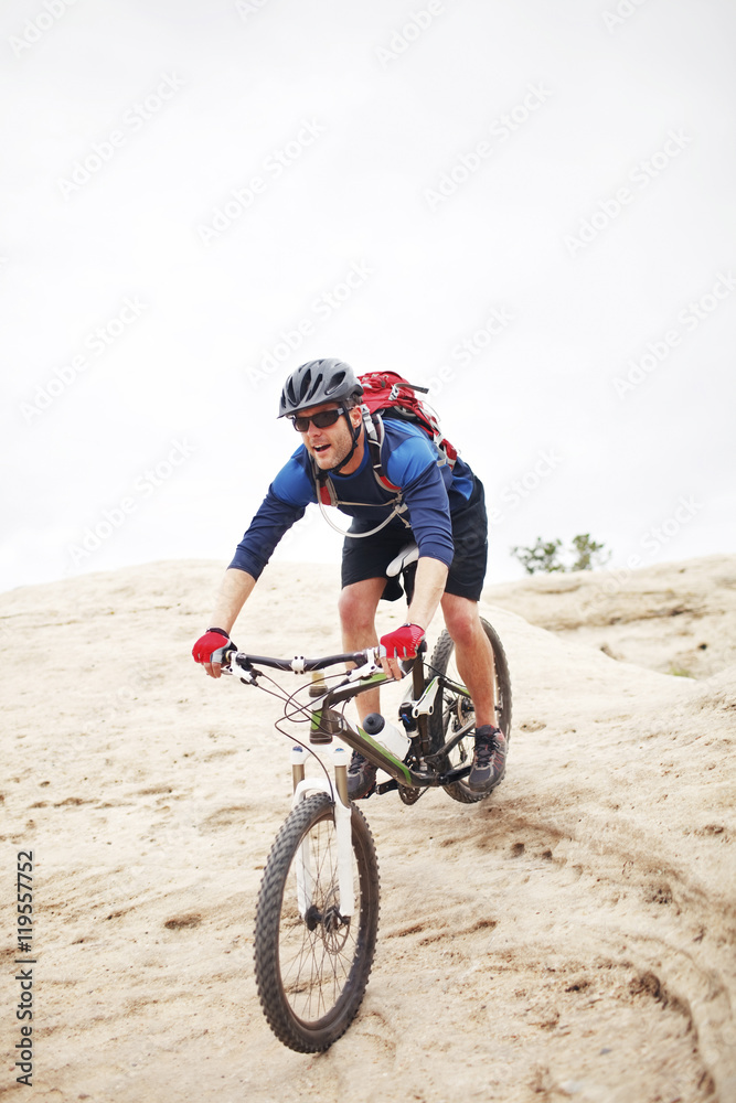 Man riding bicycle on mountain against clear sky Man riding bicycle on mountain against clear sky