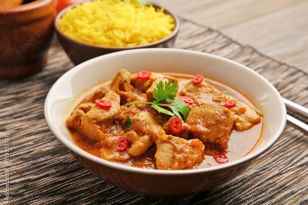 Tasty dinner with chicken curry in plate on table Tasty dinner with chicken curry in plate on table