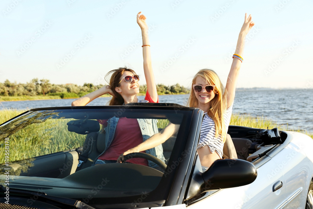 Happy friends in car