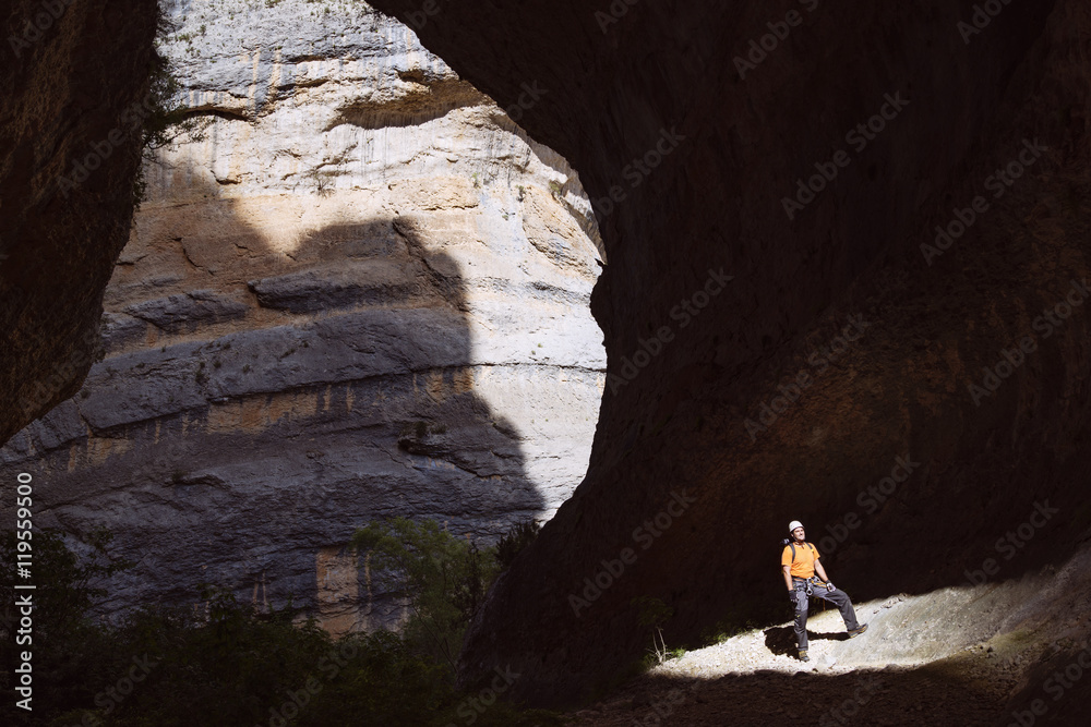 Sunlight falling on man standing in cave Sunlight falling on man standing in cave
