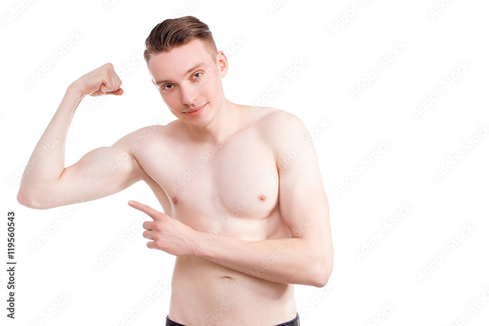 Handsome man on a white background with a naked torso in blue jeans