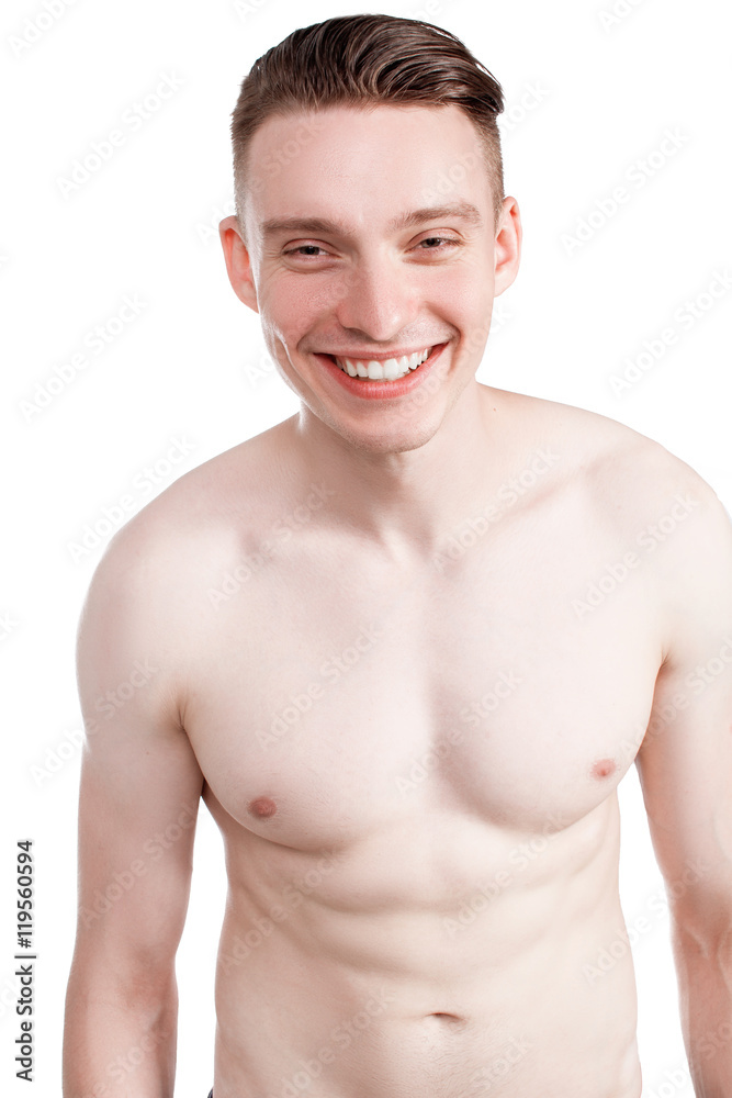 Handsome man on a white background with a naked torso in blue jeans Handsome man on a white background with a naked torso in blue jeans