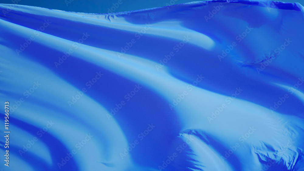 Obraz premium Light blue flag waving against clean blue sky, close up, isolated with clipping mask alpha channel transparency, perfect for film, news, digital composition
