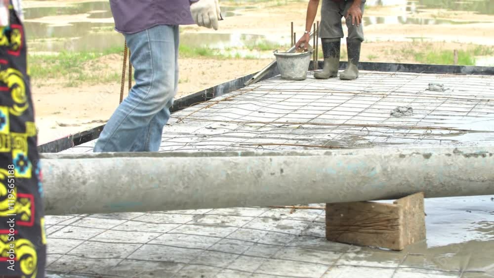 Non identify Construction workers pour concrete mix from cement mixer. Non identify Construction workers pour concrete mix from cement mixer.
