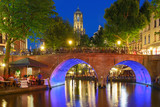 Dom Tower and canal in the night colorful illuminations in the blue hour, Utrecht, Netherlands