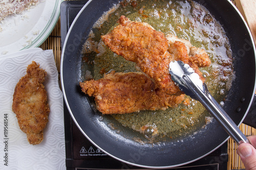 Chef deep fried pork in pan photo