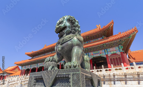Guardian Lion in front of majestic pavilion at Palace Museum, Beijing, China.