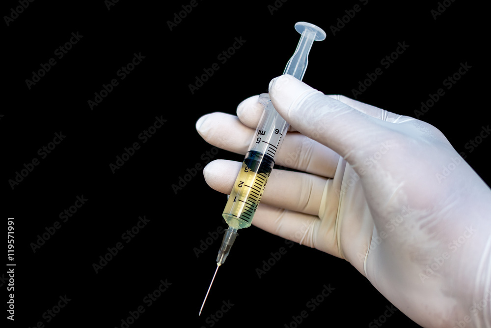 Εκτύπωση καμβά Syringe in a hand in medical gloves, ready for injection with me