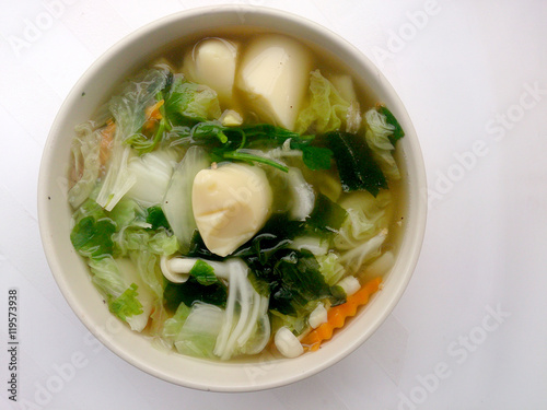 Clear Soup with Bean Curd , mix vegetable, Tofu and seaweed in white bowl on white background. Vegetarian Food, Healthy food, Thai food