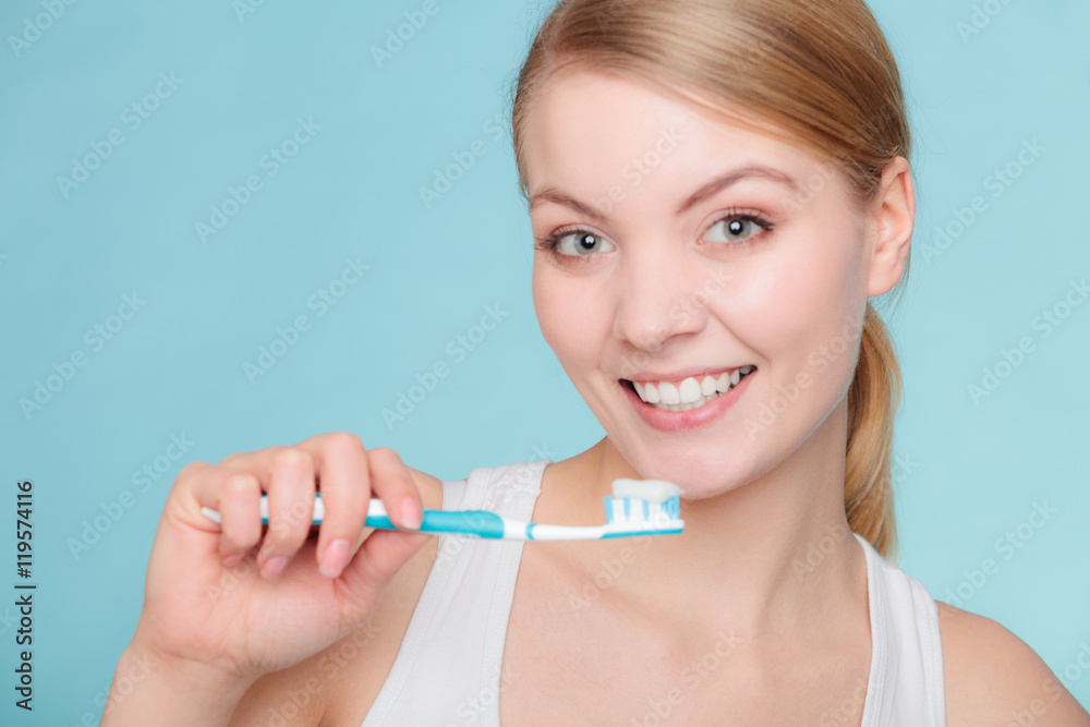 woman holds toothbrush with toothpaste cleaning teeth woman holds toothbrush with toothpaste cleaning teeth