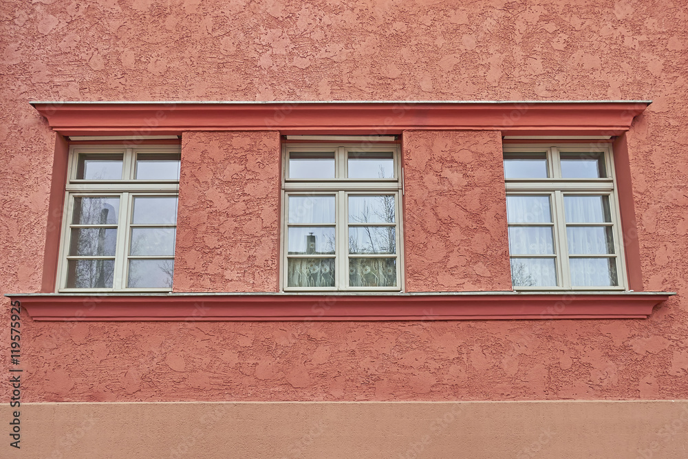 three windows row on colorful house wall three windows row on colorful house wall