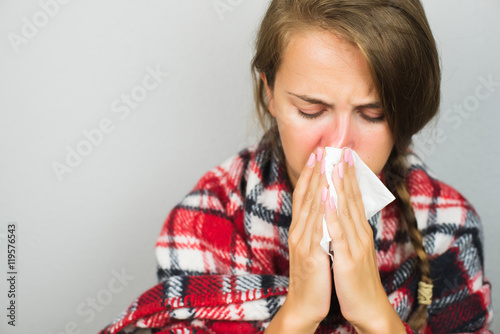 Sick woman wiping a nose photo