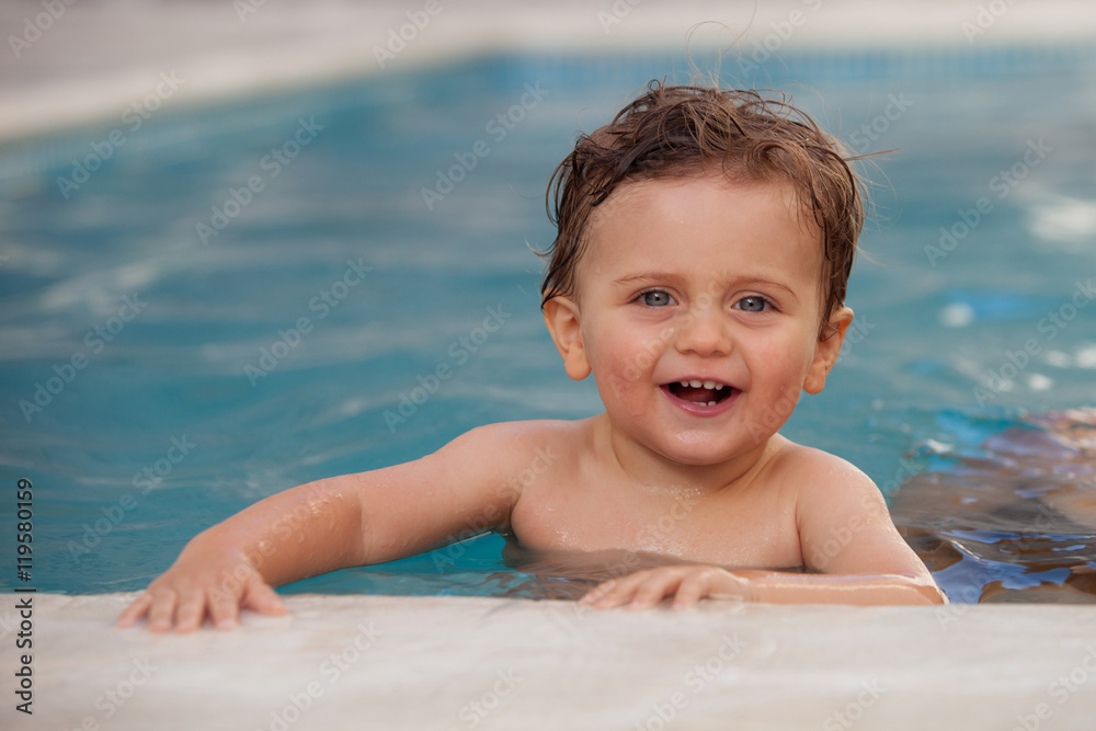 Funny baby boy in the pool