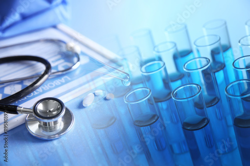 Test-tubes and medical equipment on a light blue background