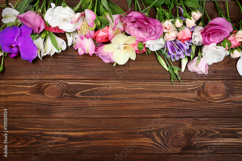 Fresh flowers on wooden background
