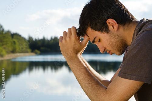 Man Praying by Lake