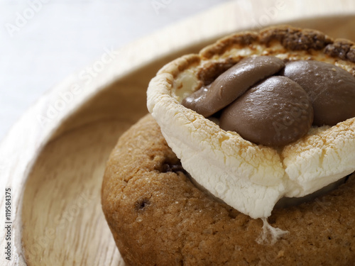 S'More dip cookies chocolate and marshmallow on wood plate photo