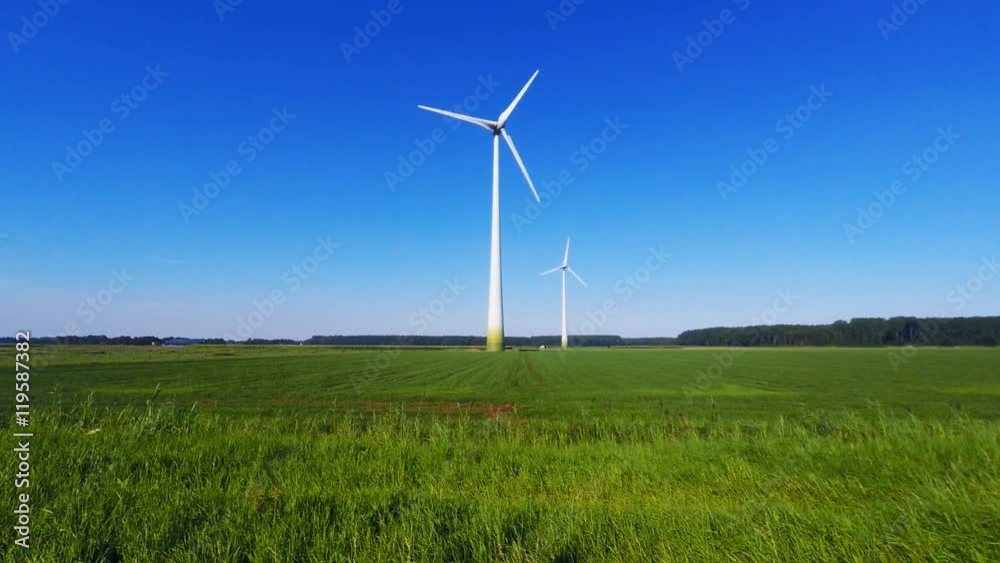 Wind turbine spinning with in a green countryside environment Wind turbine spinning with in a green countryside environment