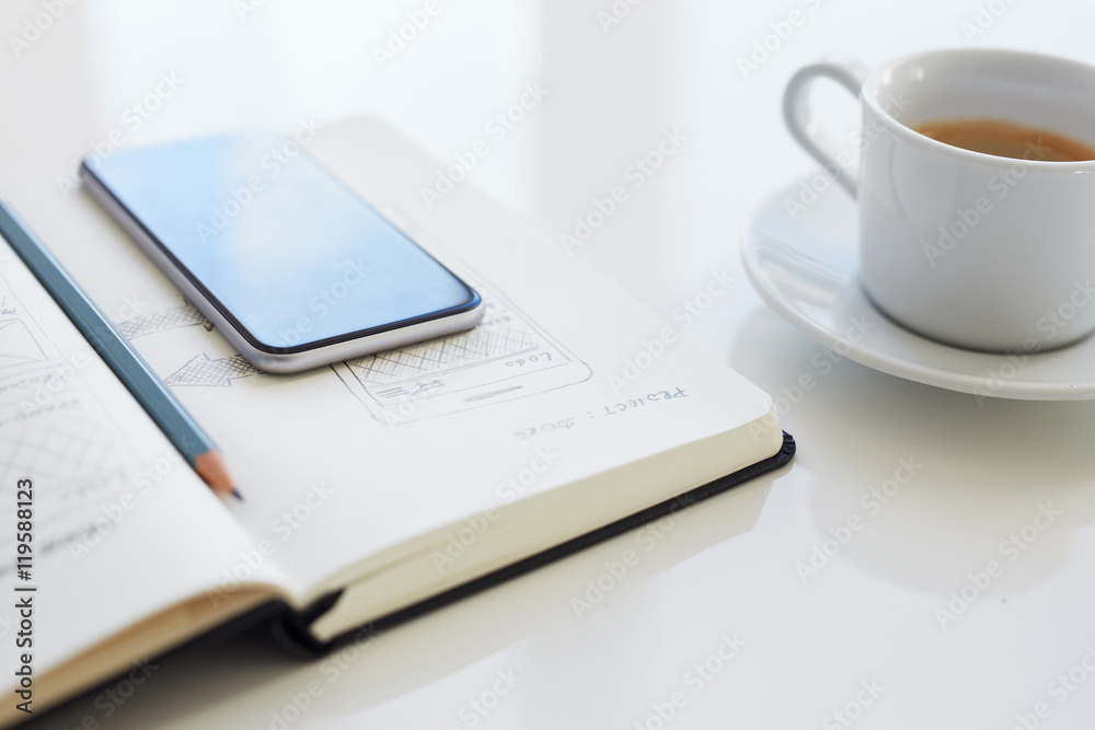 Pencil and mobile phone lying on an open diary Pencil and mobile phone lying on an open diary