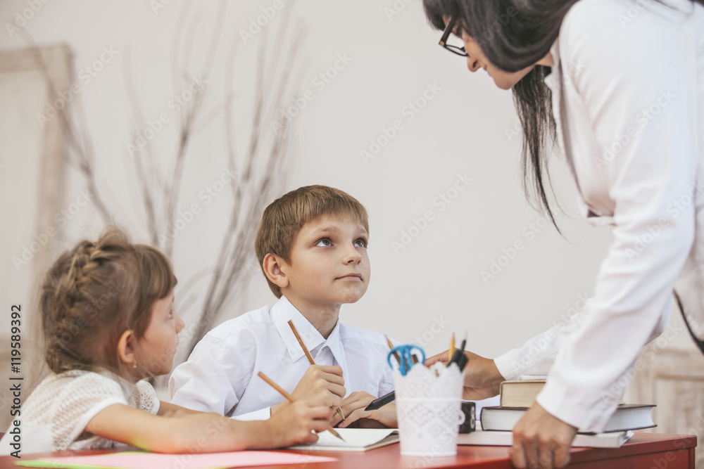 Boy and girl children with the teacher in the school Boy and girl children with the teacher in the school