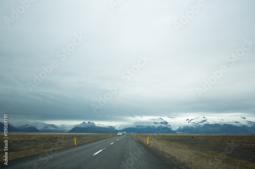 road leading to snow covered mountains. Iceland.
