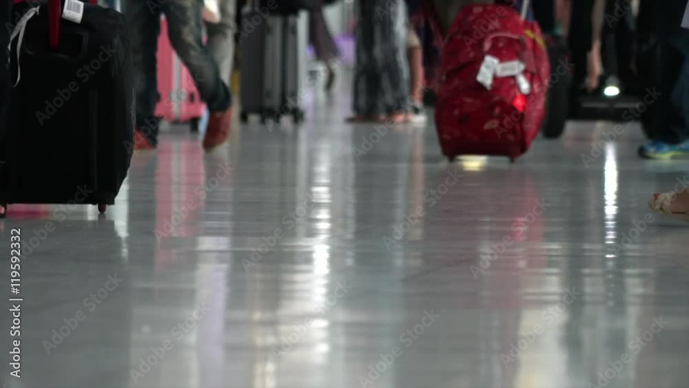 This video is about Low View of Travelers are walking with luggage in airports, M