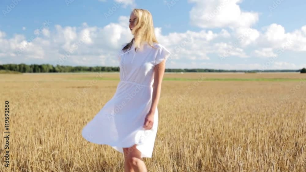 smiling young woman in white dress on cereal field smiling young woman in white dress on cereal field