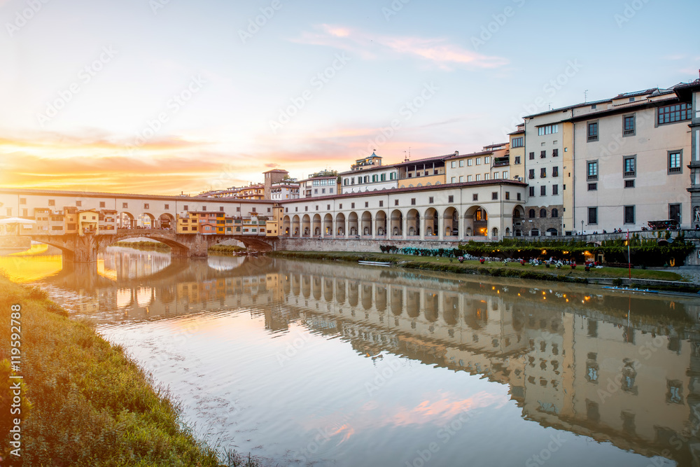 Cityscape view on Arno riverside with Canottiery arch building and famous bridge on the sunset in Florence