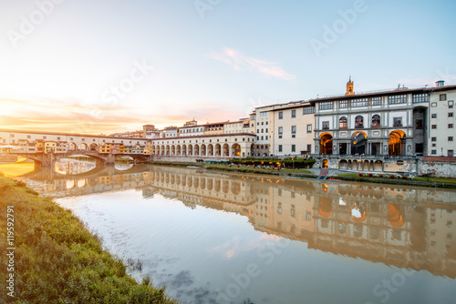 Cityscape view on Arno riverside with Canottiery arch building and famous bridge on the sunset in Florence