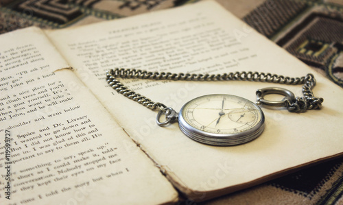 Old pocket watch on the book