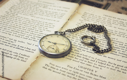 Old pocket watch on the book