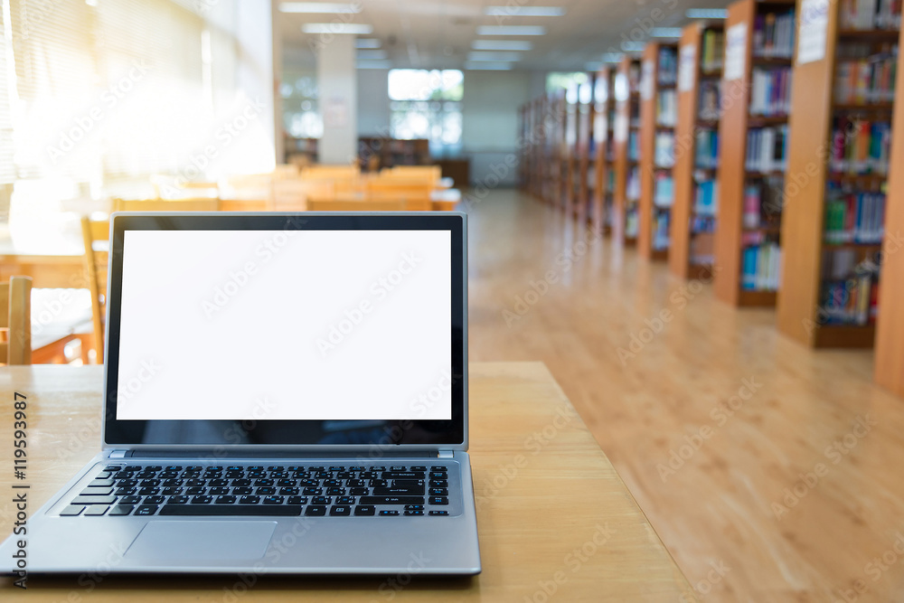 Blank screen laptop computer on the table. Blur library background. Blank screen laptop computer on the table. Blur library background.