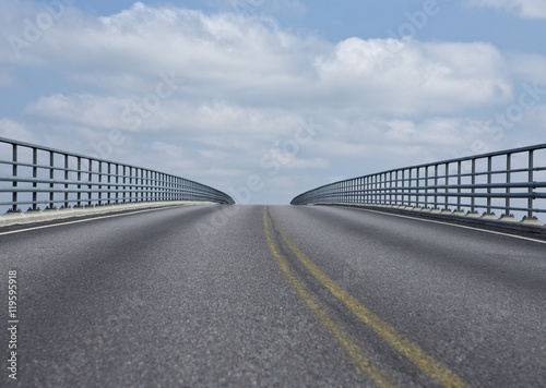 Silent road towards the sky. An asphalt road on a very high bridge.