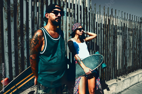 Portrait of a young skate longboarding friends at a  wall background. photo