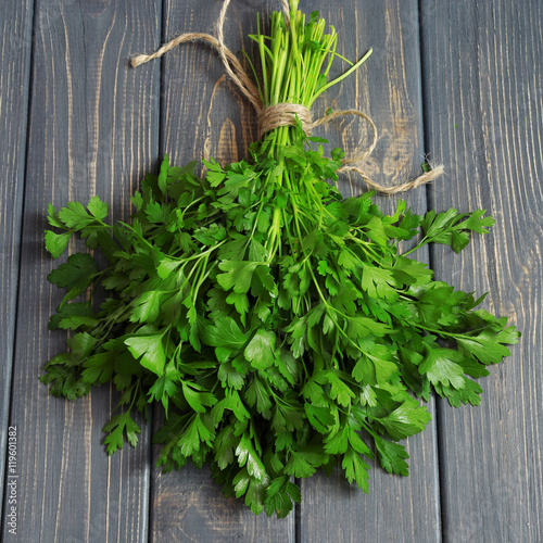 Organic bunch of parsley closeup on wooden rustic table. Top vie
