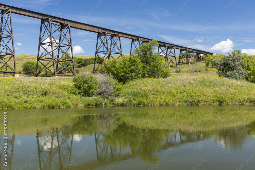 Railroad High Bridge / A long and tall railroad bridge reflecting in a river.
