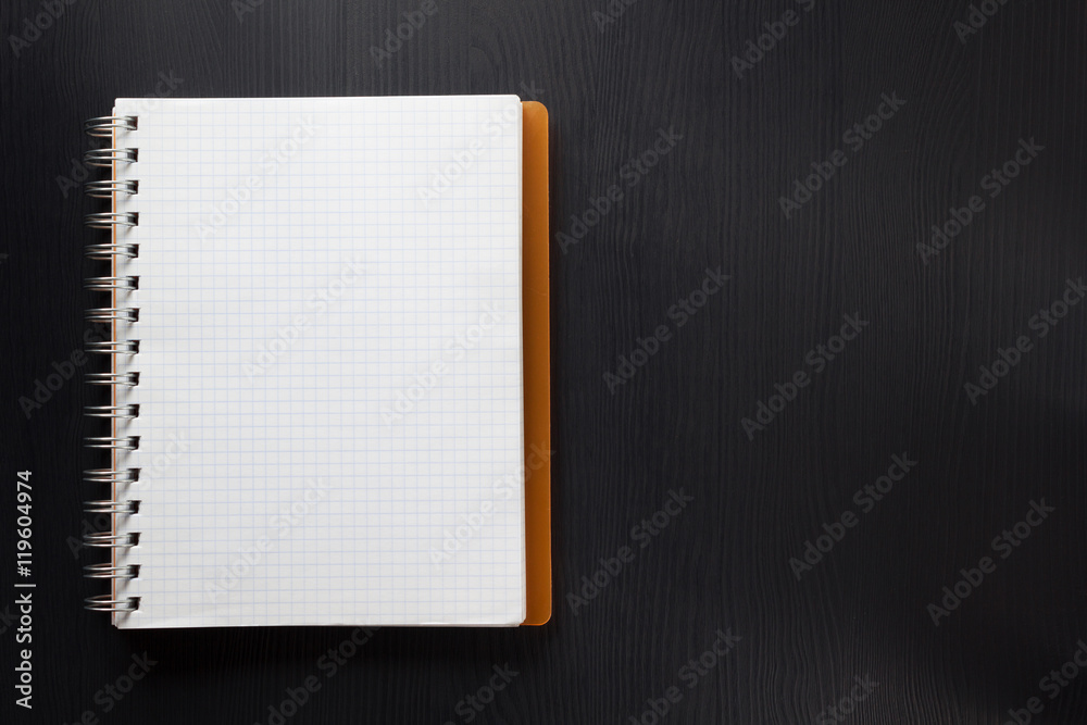 checked notebook on wood checked notebook on wood