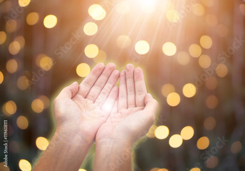 Woman giving or holding hands on celebration bokeh background.