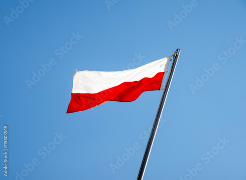 Poland flag fluttering on a metal flagpole 