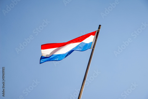 Flag of Luxembourg fluttering on a metal flagpole 
