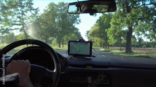 GPS navigation in car with man driving 4K. Close up on navigation screen showing road to follow. Smartphone navigation device.