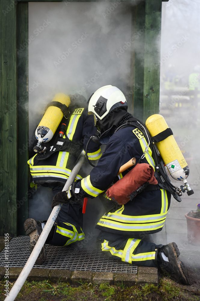 Fototapeta premium Feuerwehrmänner bei Löscharbeiten